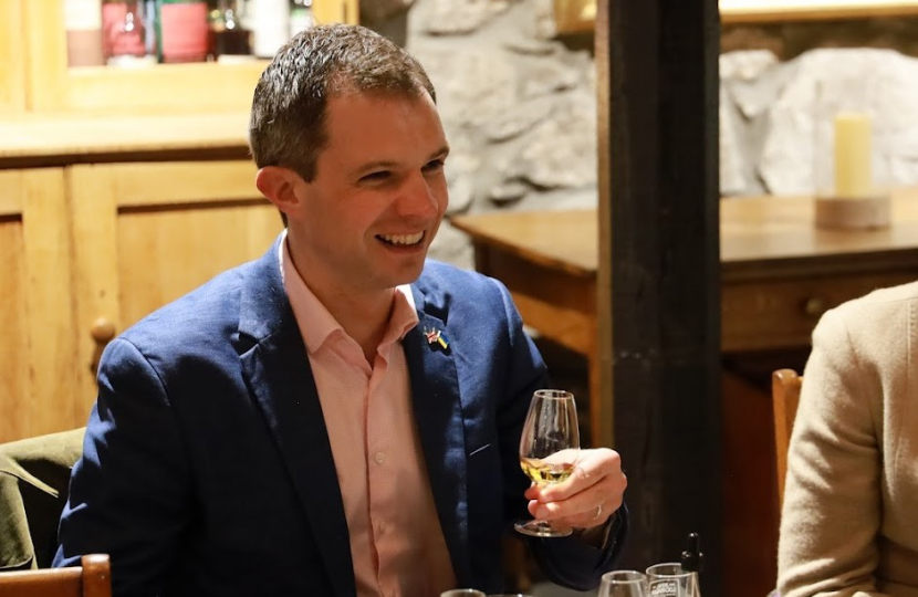 Andrew Bowie visiting a distillery 
