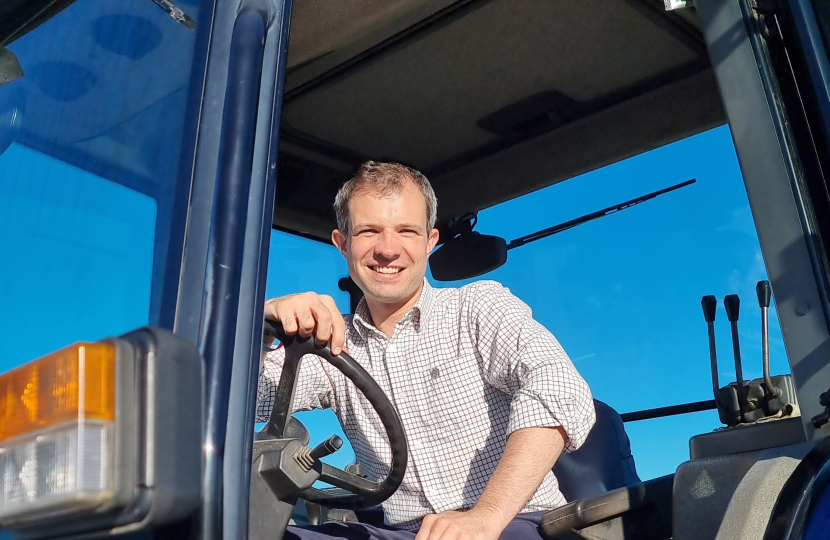 Andrew Bowie MP sitting in a tractor