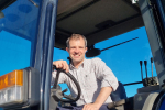 Andrew Bowie MP sitting in a tractor