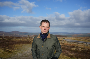 Andrew Bowie standing in a rural part of the constituency